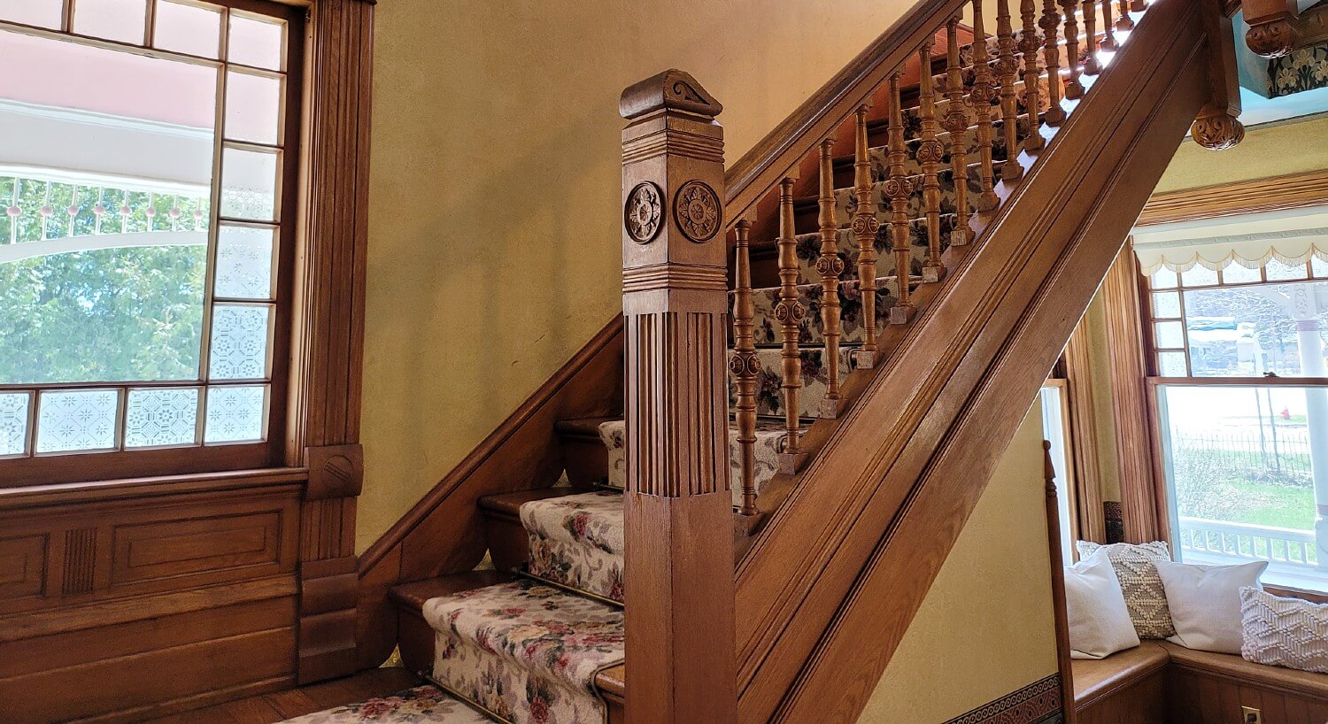 Inside of a home showing a large stately stairway leading to an upper level